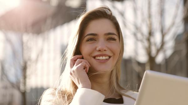 Young woman smiling while on phone
