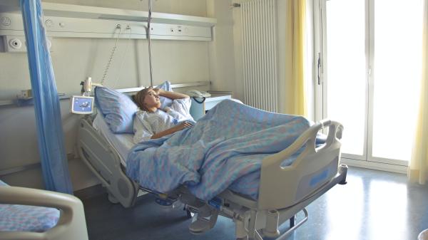 Photo of woman lying in hospital bed