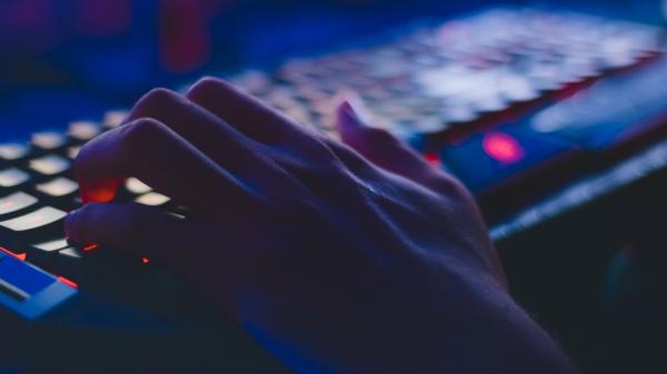Lights illuminate a keyboard as a single hand types
