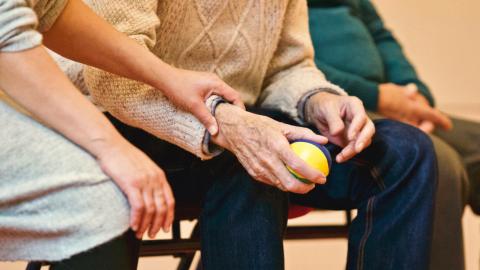 Photo of an elderly man holding a ball
