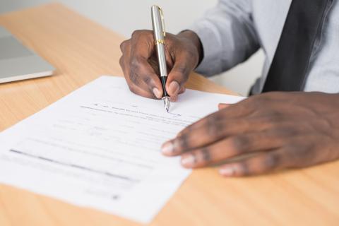 Photo of a man's hands as he writes