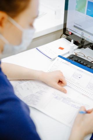 A health practitioner looks an information.
