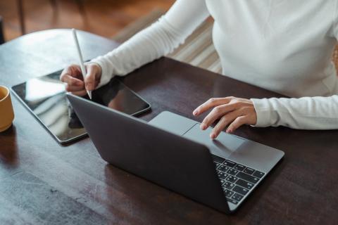 Photo of laptop and person working